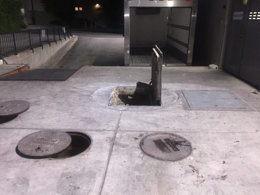 open lids of a commercial kitchen plumbing instrument that needs grease trap cleaning in Los Angeles, California, Co ordinate of the location : 34.0522° N, 118.2437° W